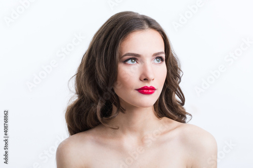 Indoor portrait of beautiful brunette young woman on white background.