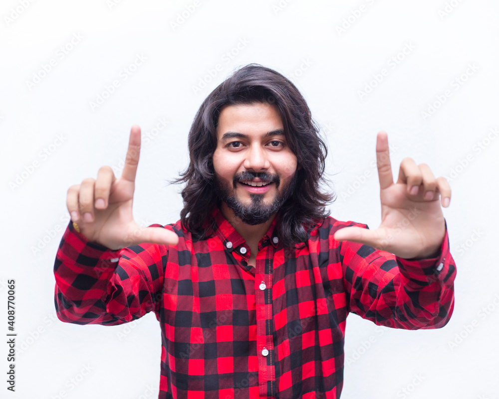 Close-up portrait of a young man focusing object. Stress-free. Human facial expression, emotion, feeling, sign symbol body language Close-up portrait of a young man focusing object. Stress-free. Human facial expression, emotion, feeling, sign symbol body language