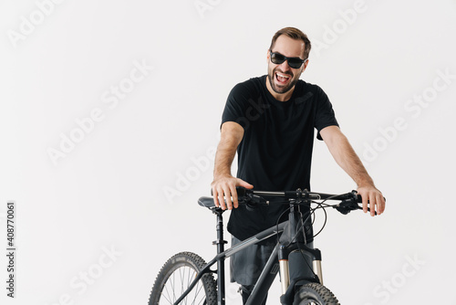 Happy cyclist sportman with a bicycle isolated