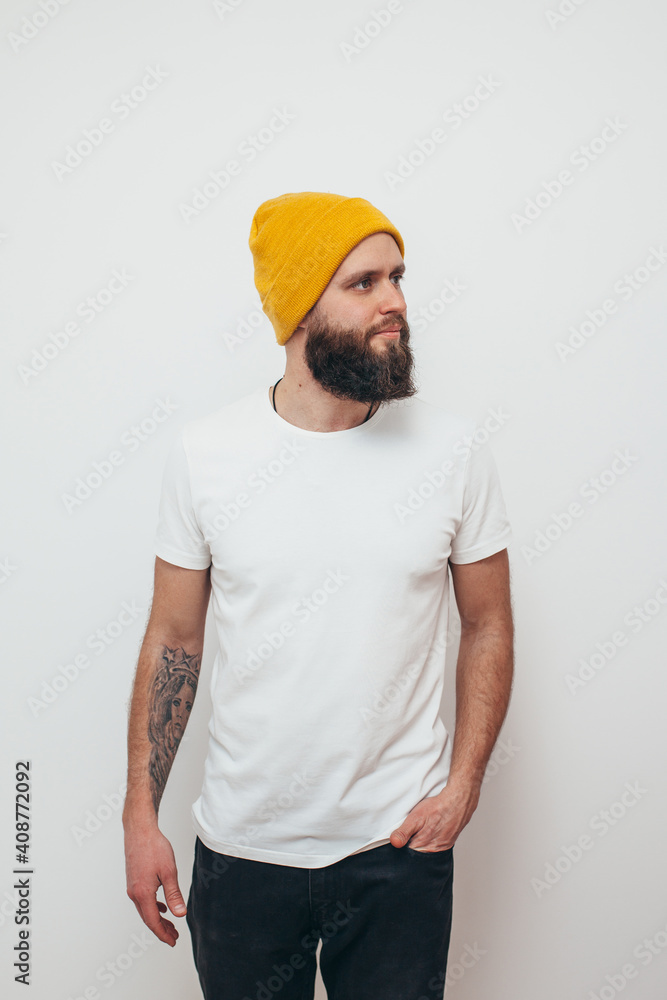 Young bearded hipster guy wearing white blank t-shirt. Mock-up for print. T-shirt template. Young bearded hipster guy wearing white blank t-shirt. Mock-up for print. T-shirt template.