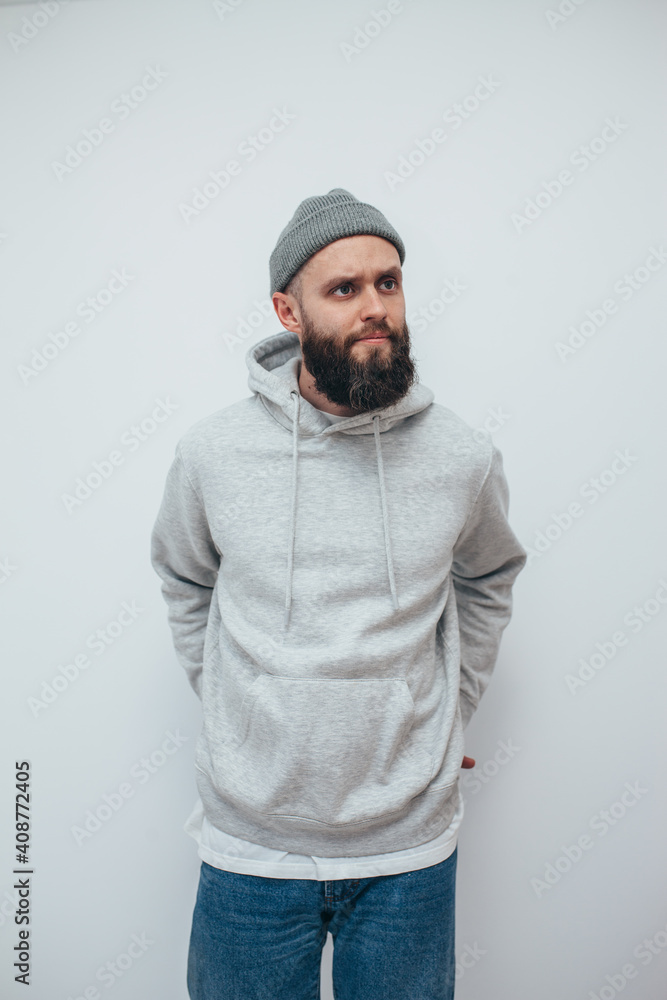 Handsome hipster guy with beard wearing gray blank hoodie with space for your logo or design. Mockup for print Handsome hipster guy with beard wearing gray blank hoodie with space for your logo or design. Mockup for print