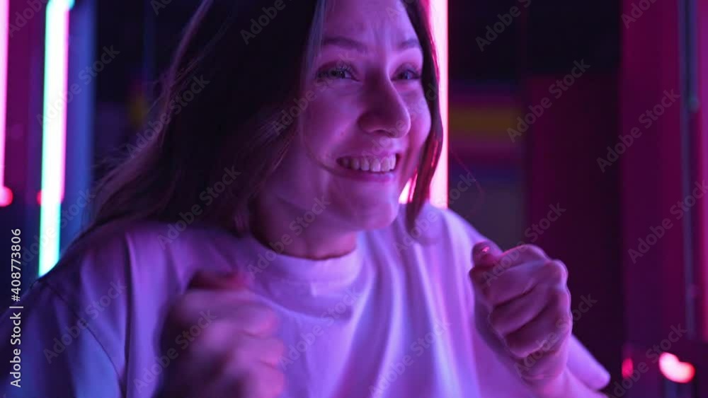 Person winner. Neon background. Success in competition, victory and winning Person winner. Neon background. Success in competition, victory and winning