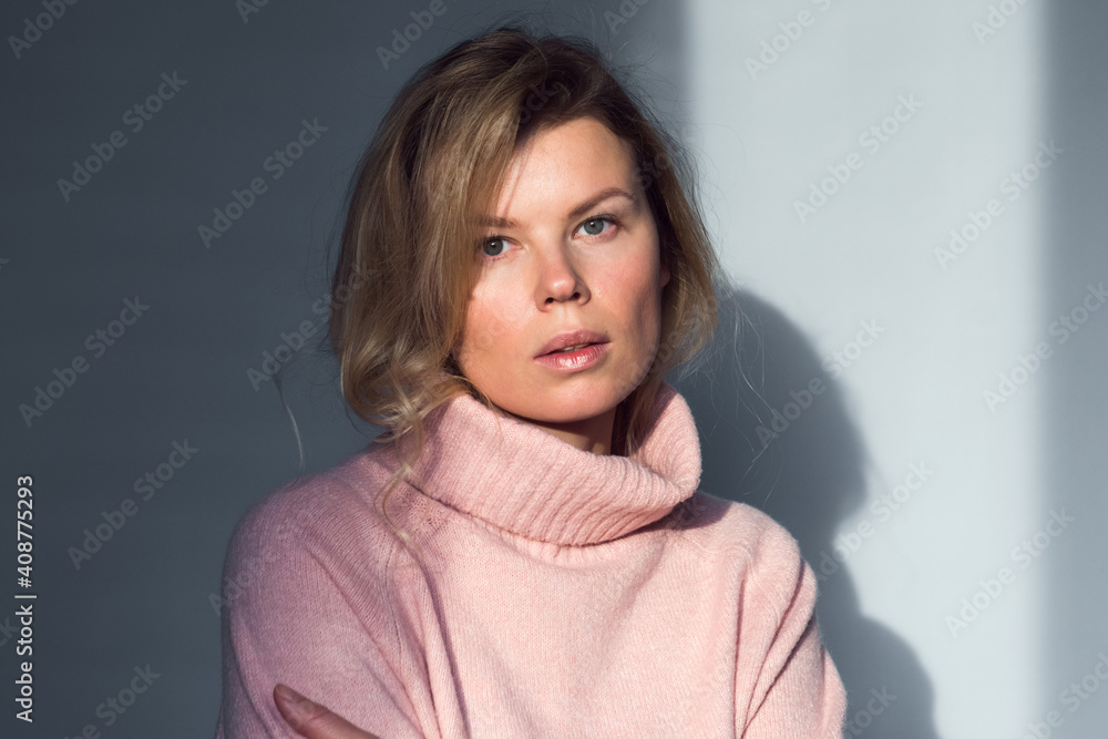 adult beautiful woman pink sweater look at camera gray background, sunlight, minimalistic lifestyle portrait adult beautiful woman pink sweater look at camera gray background, sunlight, minimalistic lifestyle portrait