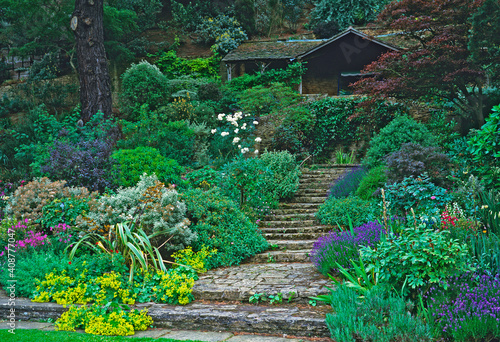 Steps leading up sloping garden to a Country House