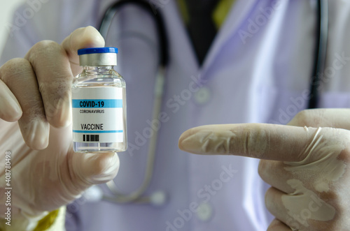 Doctor or laborant holding COVID-19 vaccine tube Or coronavirus vaccine