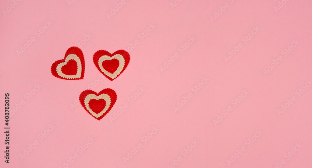 Red hearts on gently pink background. St Valentine’s day top view flat lay. Love romantic relationship concept. Copy space for text. The symbol of love and family.