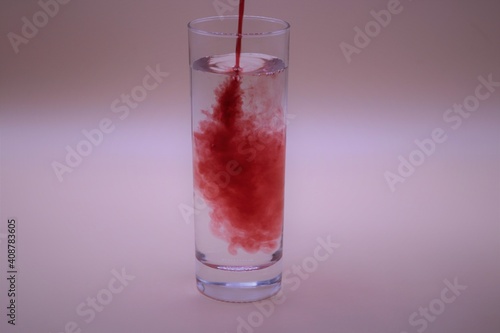 Wallpaper Mural Red liquid being poured into a glass of water Torontodigital.ca