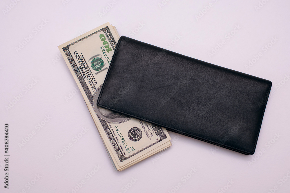 One hundred dollar bill in a black wallet on a white background top view One hundred dollar bill in a black wallet on a white background top view