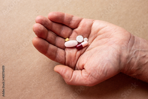 Male hand with medicines pills
