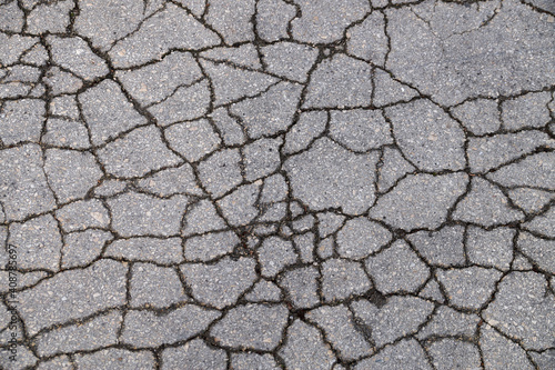 gray texture of cracked asphalt for background