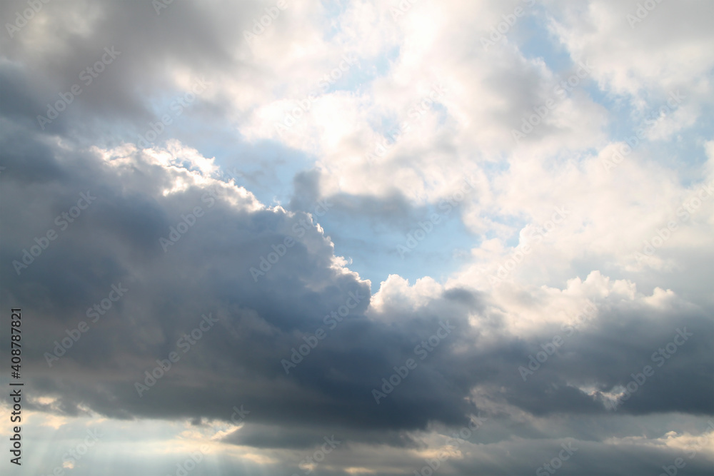 A beautiful horizontal shot of bright blue sky with fluffy white clouds. Dramatic view. grey clouds over the sea. summer sunset