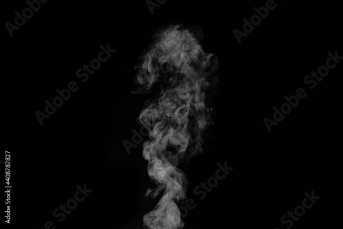 White vapour spray steam from air saturator. Smoke fragments on a black background. Abstract background, design element, for overlay on pictures