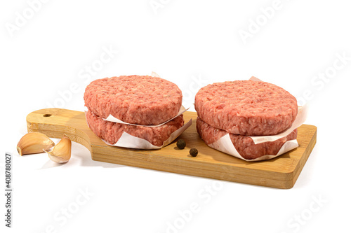 Raw beef patties for a burger.Selective focus.Isolated on a white background.