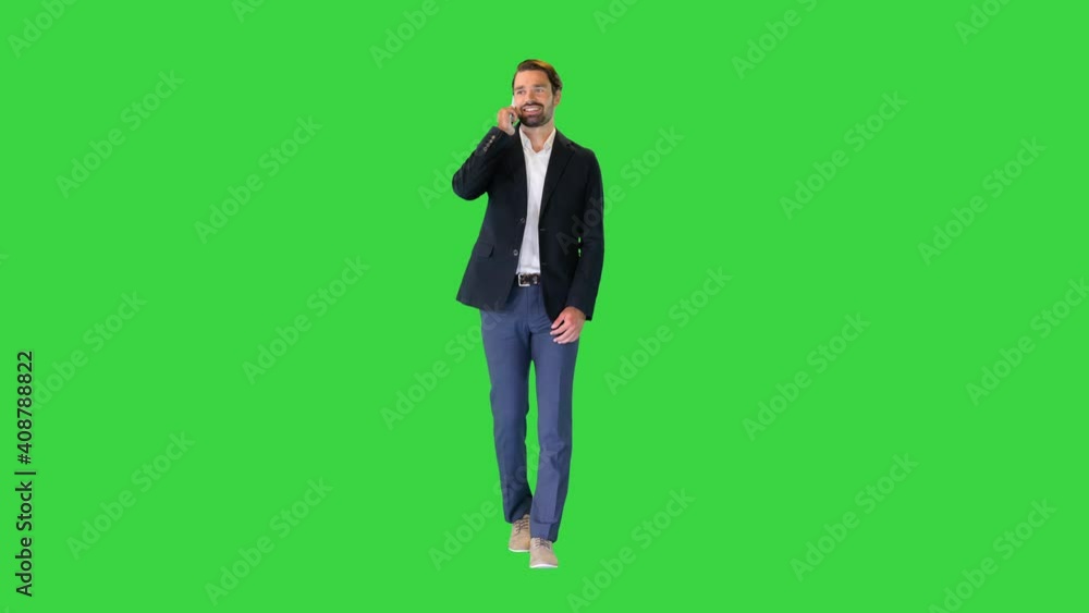 Business man walking forward while talking on the phone on a Green Screen, Chroma Key. Business man walking forward while talking on the phone on a Green Screen, Chroma Key.