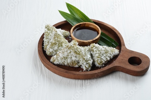 Kue lupis is an traditional Indonesian sweet sticky rice.made of glutinous rice with grated coconut and served with palm sugar syrup