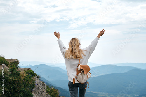 Girl enjoy scenics view on valley. Beautiful nature landscape in mountains. Hiking journey on tourist trail. Outdoor adventure. Travel and exploration. Healthy lifestyle, leisure activities