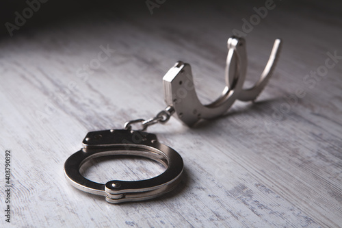 closeup of handcuffs on obscure stainless steel