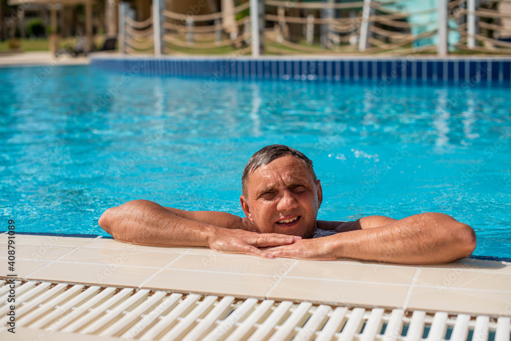 handsome guy half-naked cheerful man smiling laughing in blue water ...