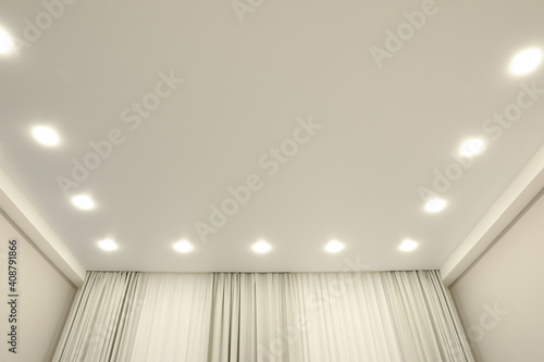 White stretch ceiling with spot lights in room