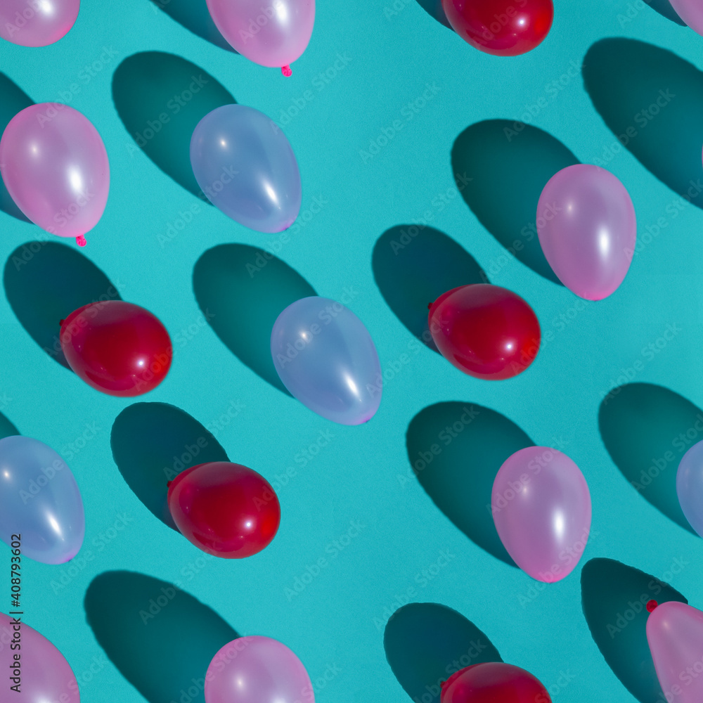 Seamless pattern of pink, red, lilac balloons on a blue background