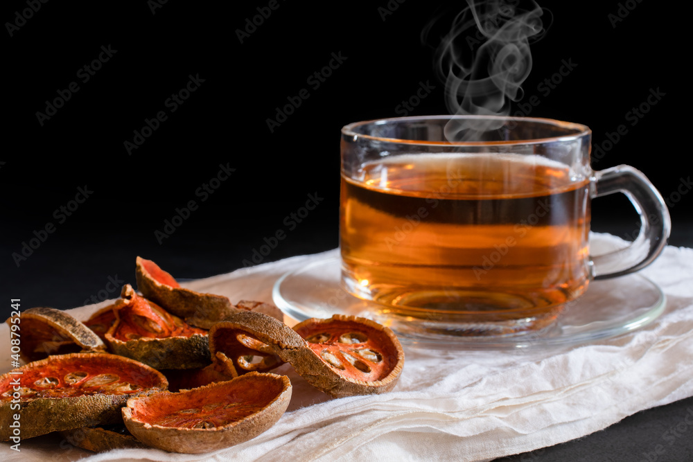 Hot bael fruit tea in a clear cup with hot steam Bael Fruit Tea made from dried bael fruit Stock