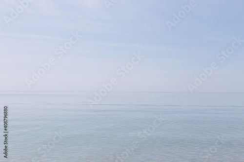 Clear and blue sea with a soft horizon