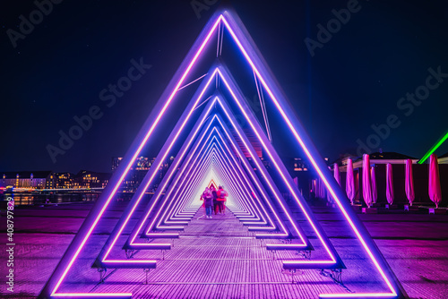 Fotografie, Obraz Purple coloured gate of light or purple light tunnel installation made of triang