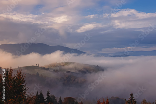 Beautiful mountain landscape. Sky with clouds and fog on the hills