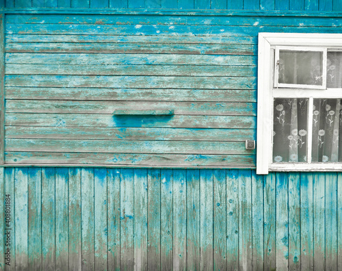 Fragment of an old rustic wooden blue house