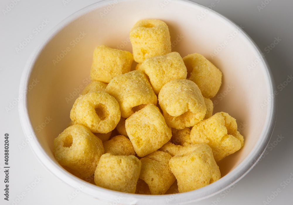 Crispy Corn rings salty snacks in bowl. Fast food or junk food snacks unhealthy concept. Crispy Corn rings salty snacks in bowl. Fast food or junk food snacks unhealthy concept.