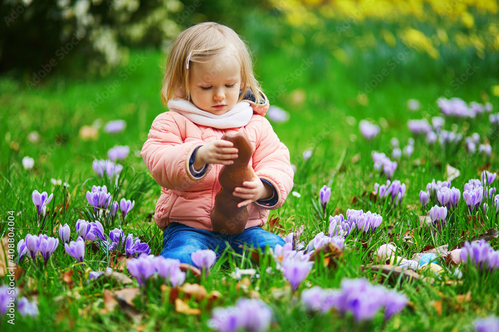 Cute little girl playing egg hunt on Easter Cute little girl playing egg hunt on Easter