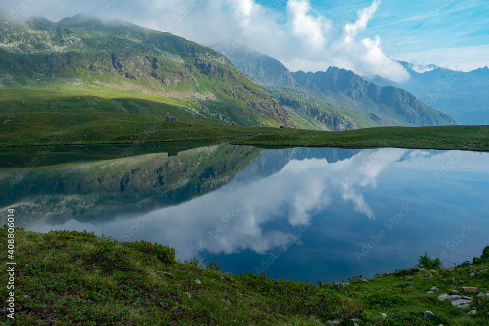 Lago di Malghera in the Italian Alps: Beautiful reflections of mountains and sky