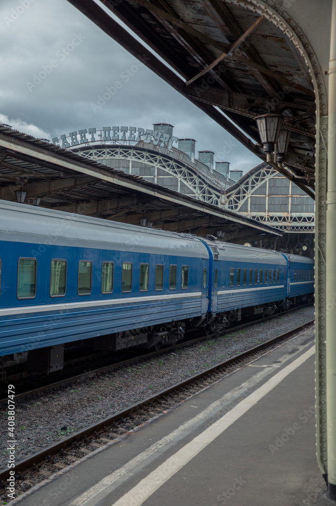 View of the platform of the railway station and the train with blue carriages. Vitebsky railway station St. Petersburg.
