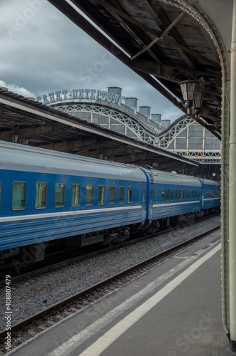 View of the platform of the railway station and the train with blue carriages. Vitebsky railway station St. Petersburg.