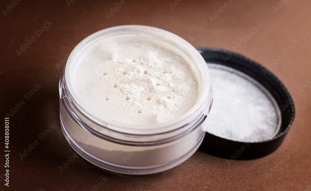 Skin matting powder on a brown background. White powder. Skin matting powder on a brown background. White powder.