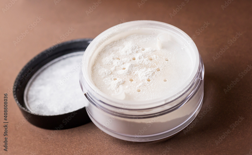 Skin matting powder on a brown background. White powder. Skin matting powder on a brown background. White powder.