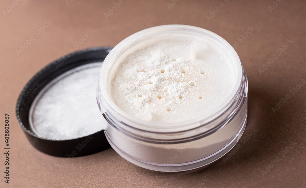 Skin matting powder on a brown background. White powder. Skin matting powder on a brown background. White powder.