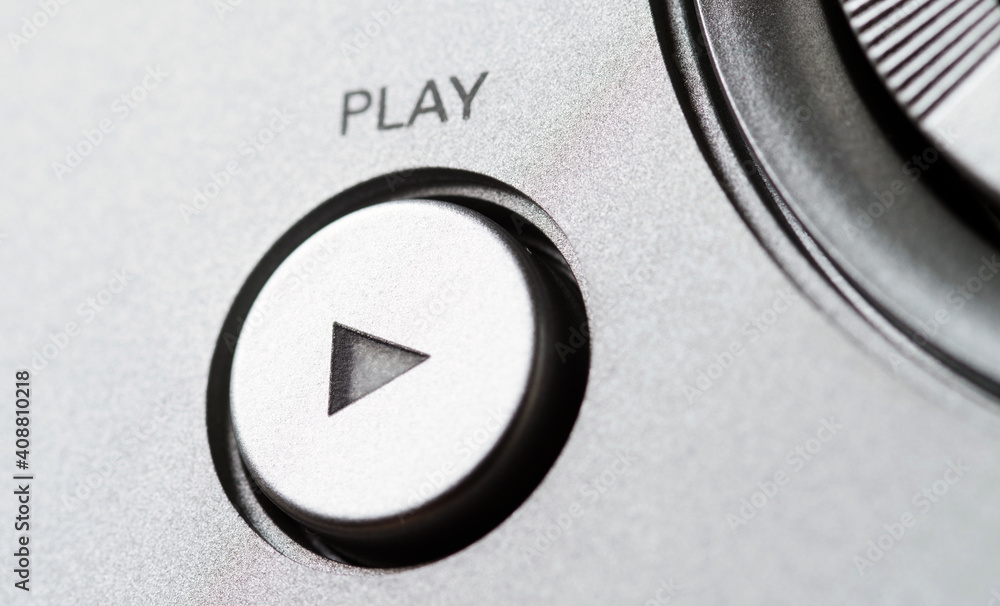 A movie playback button on a control panel and selector switch. Selective focus. A movie playback button on a control panel and selector switch. Selective focus.