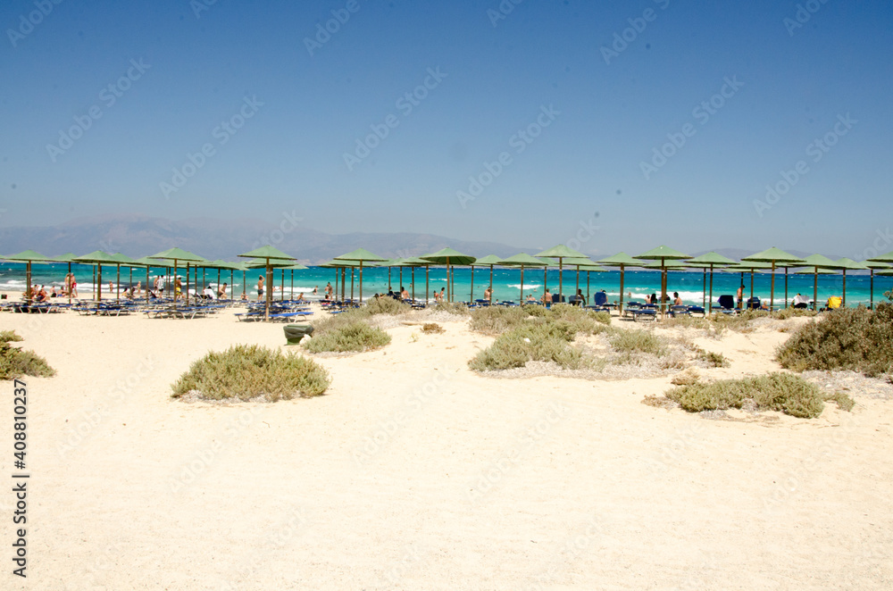 sand beach with umbrellas and sea on the island Chrisi, Crete
