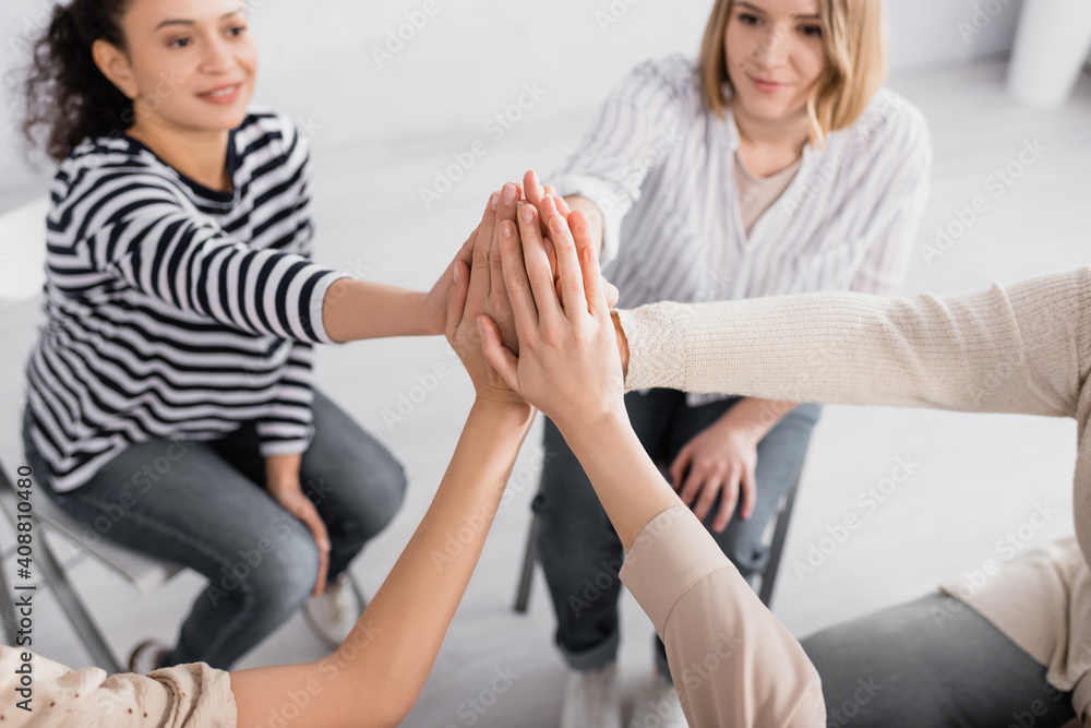 group of multicultural women holding hands together during seminar group of multicultural women holding hands together during seminar