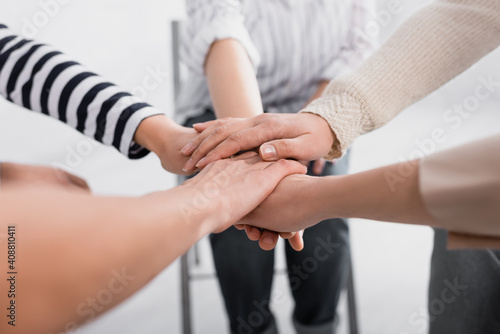 partial view of group of women holding hands together during seminar
