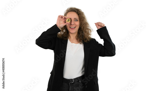 Business woman holds a bitcoin and celebrates the profits. White background.