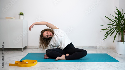 Young woman doing yoga at home during the Coronavirus or Covid 19 quarantine.