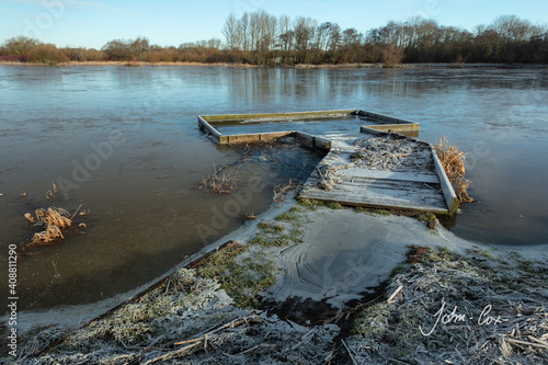 Картината върху платно Disused and decayed wooded jetty on a large pond