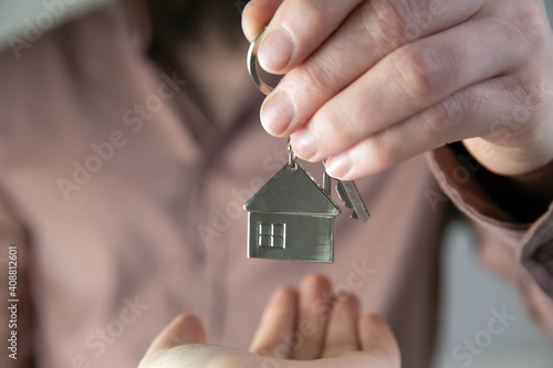Estate agent giving house keys to client for new home, contract real estate for mortgage approved, focus on keys, business, financial, Estate concept
