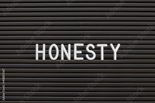 White alphabet in word honesty on black color felt letter board background