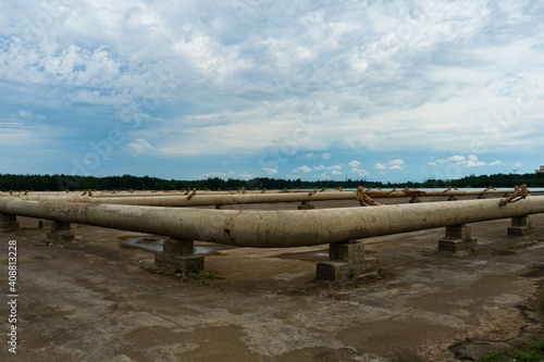 Pipes of the cooling system of a thermal power plant on concrete supports. Empty Spray Pond Cooling System