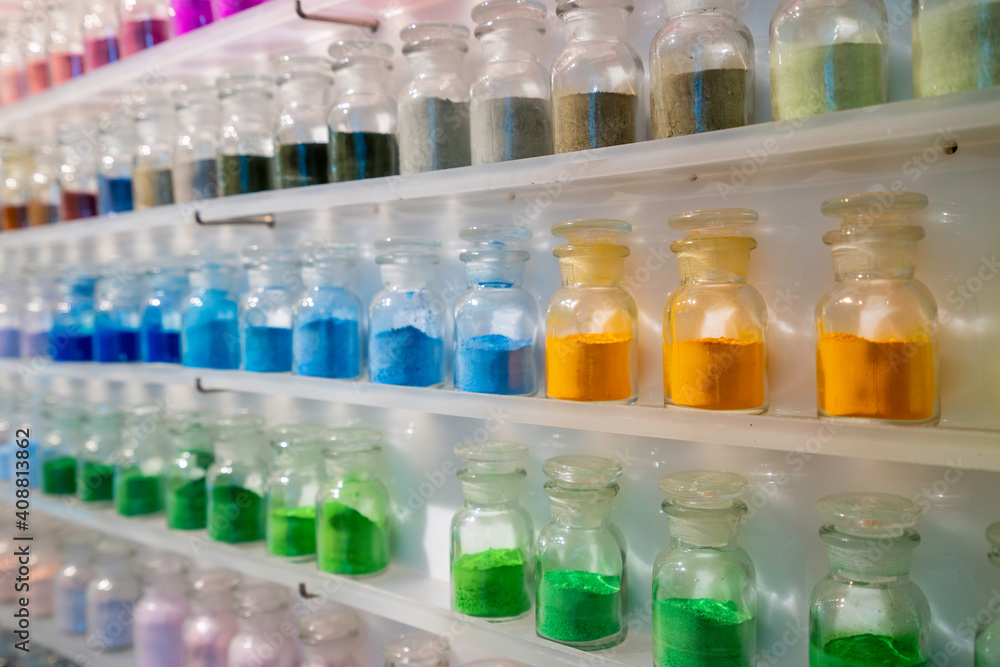 Row of colorful dry powder in glass bottle Row of colorful dry powder in glass bottle