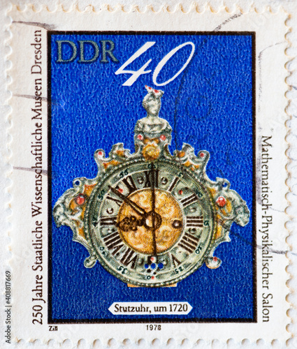 GERMANY, DDR - CIRCA 1978  : a postage stamp from Germany, GDR showing an Augsburger Stutzuhr (1710) Text: Mathematisch Physikalischer Salon photo