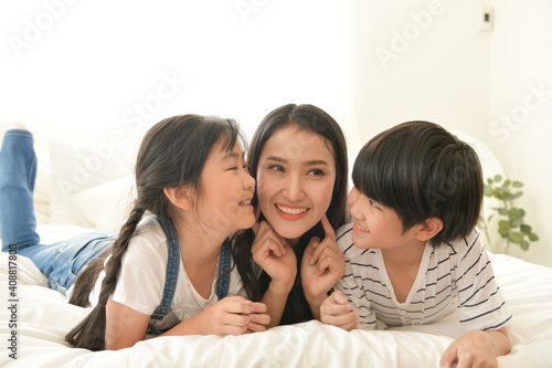 Family happy moments when children wake up in the morning. Have fun with mom before eating breakfast.